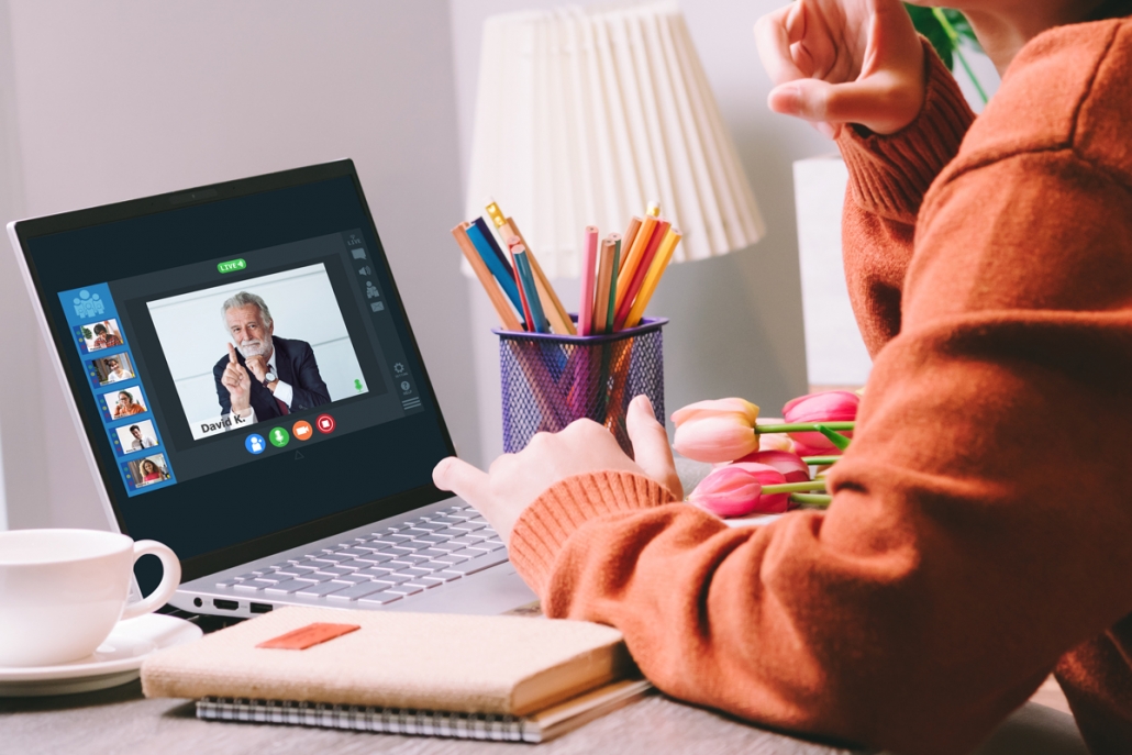 Image of person working remotely on computer conference with peers