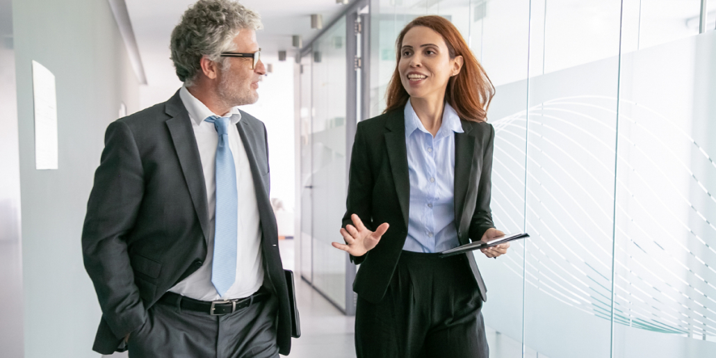 confident, assertive communicator woman speaking to work colleague