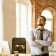 workplace ego article image header. image of business man with ego standing in office