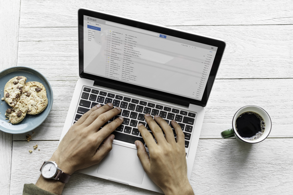 email subject line article - hands typing on laptop for email