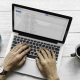 email subject line article - hands typing on laptop for email